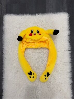 Yellow plush Pikachu hat with interactive moving ears.
